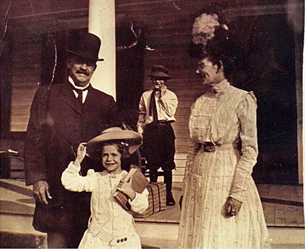 Oscar Landon Miles with wife Mary Lee and children Charlotte, age 6 and Fanning.  Photo taken on the porch of their home in Booneville or Ft. Smith, Ark.
