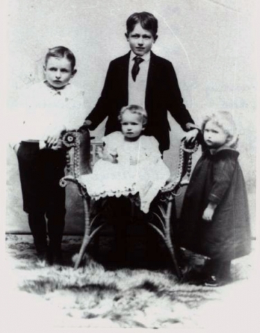 John and Lelah Craws children, Behind chair, Andrew, left, Clarence, seated, George who died just after photo was made, on right is Kitty Pearl (Craw) Miles, future wife of Ray Francis Miles 